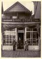 Image of C. M. Pessemier in doorway of his shoe store, Seattle, circa 1891